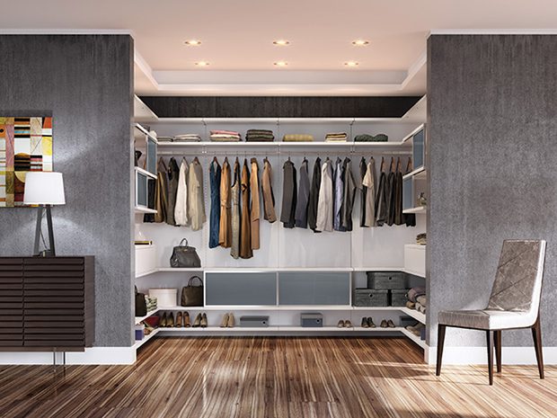 U-shaped walk in closet with open shelving and storage for shoes by California Closets