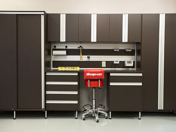 Custom garage workbench in dark brown finish with aluminum accents created by California Closets
