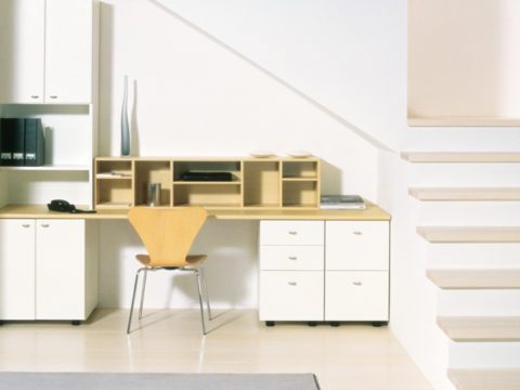 White Under Stairs Office Nook with Shelving Drawers Cabinets and Light Wood Desk Top and Cubbies