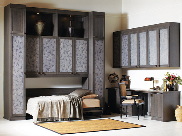 Murphy bed design with patterned cabinet storage and dark wood grain finish by California Closets