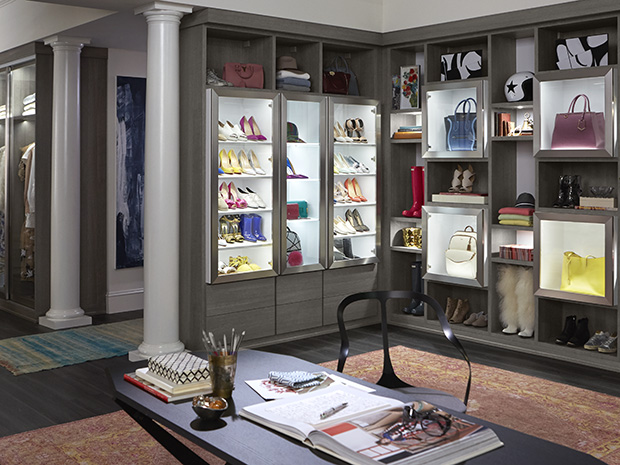 Large walk in cloffice with lighted shoe storage and writing desk for a bloggers home by California Closets