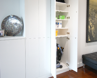 Classic white storage solution integrated with white shelving and hidden hardware
