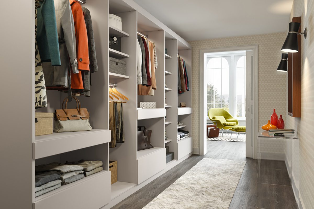 Walk in closet designed in a long hallway with floor to ceiling customized storage by California Closets