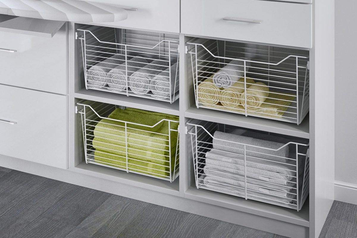Linen closet white wire baskets design for towels and bedding by California Closets