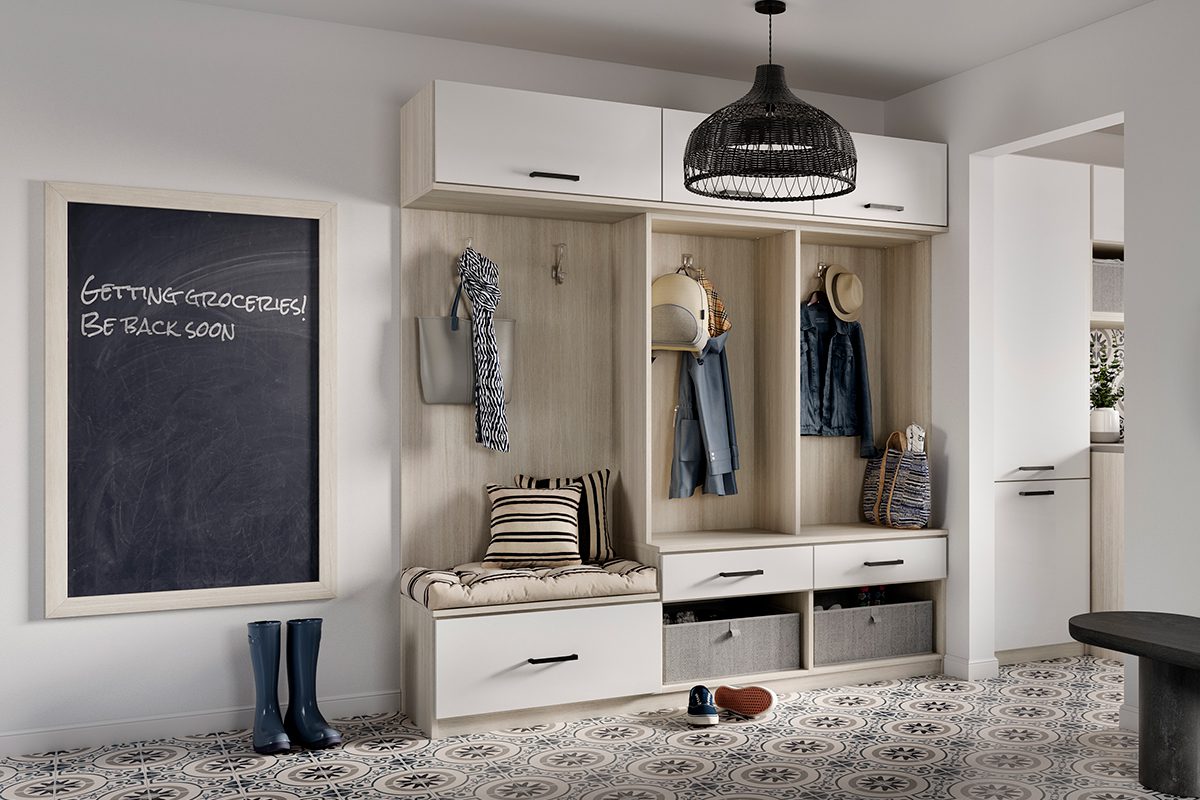 Mudroom entyway with open shelving, custom cabinets, bench and chalkboard created by California Closets