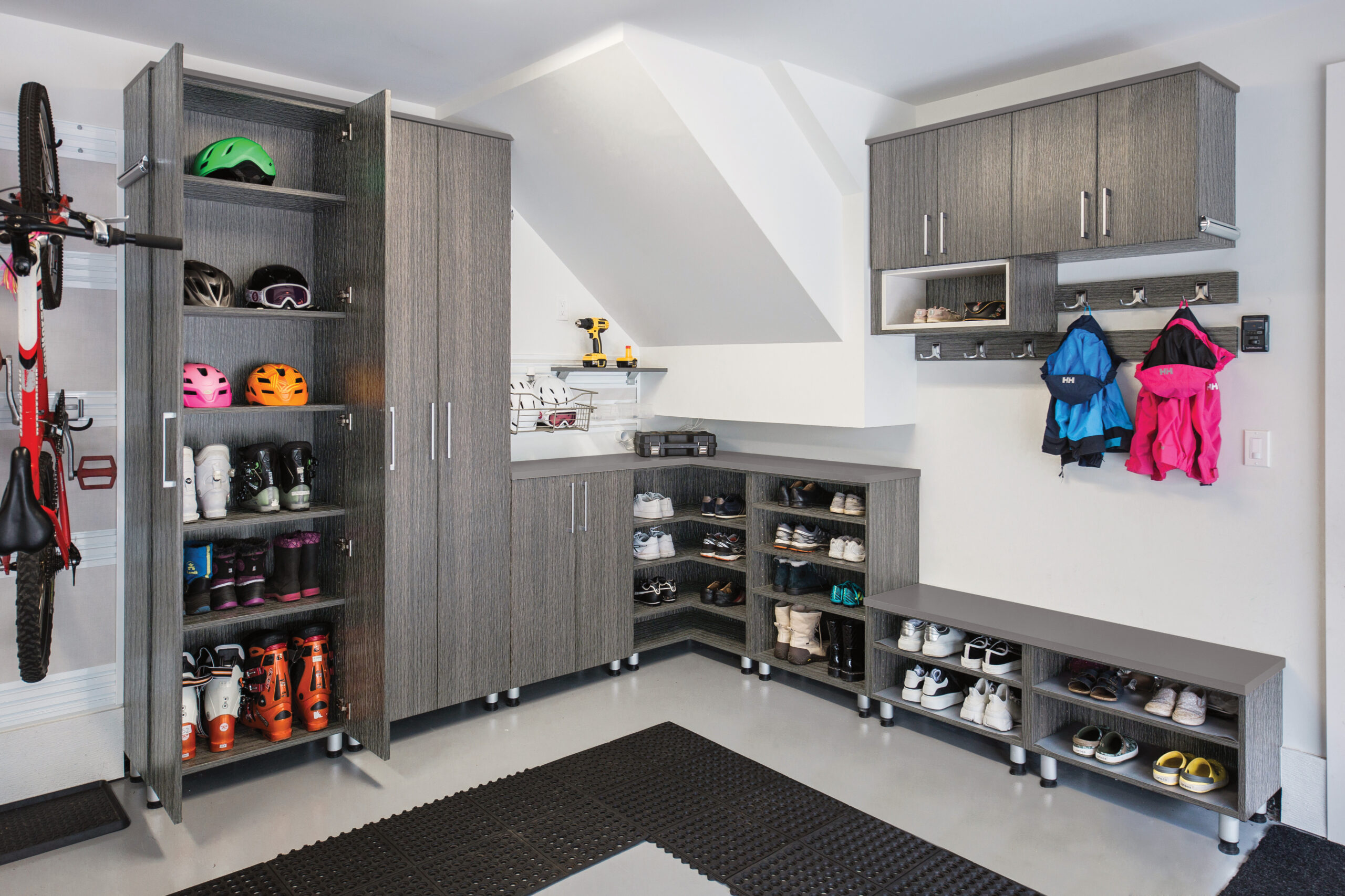 Custom solution for the garage complete with shoe and boot storage by California Closets